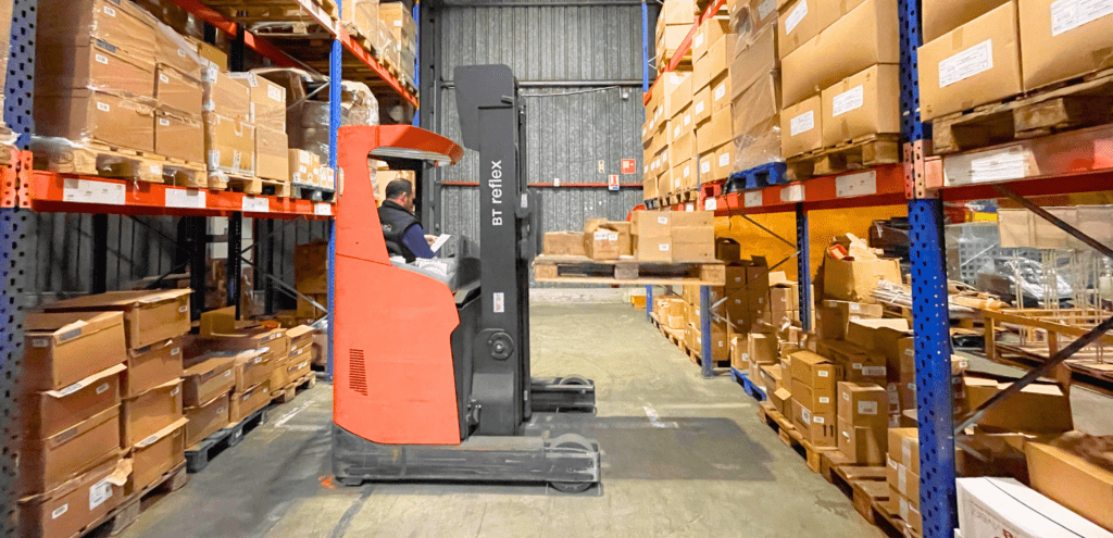 Cyril using a forklift to move a pallet